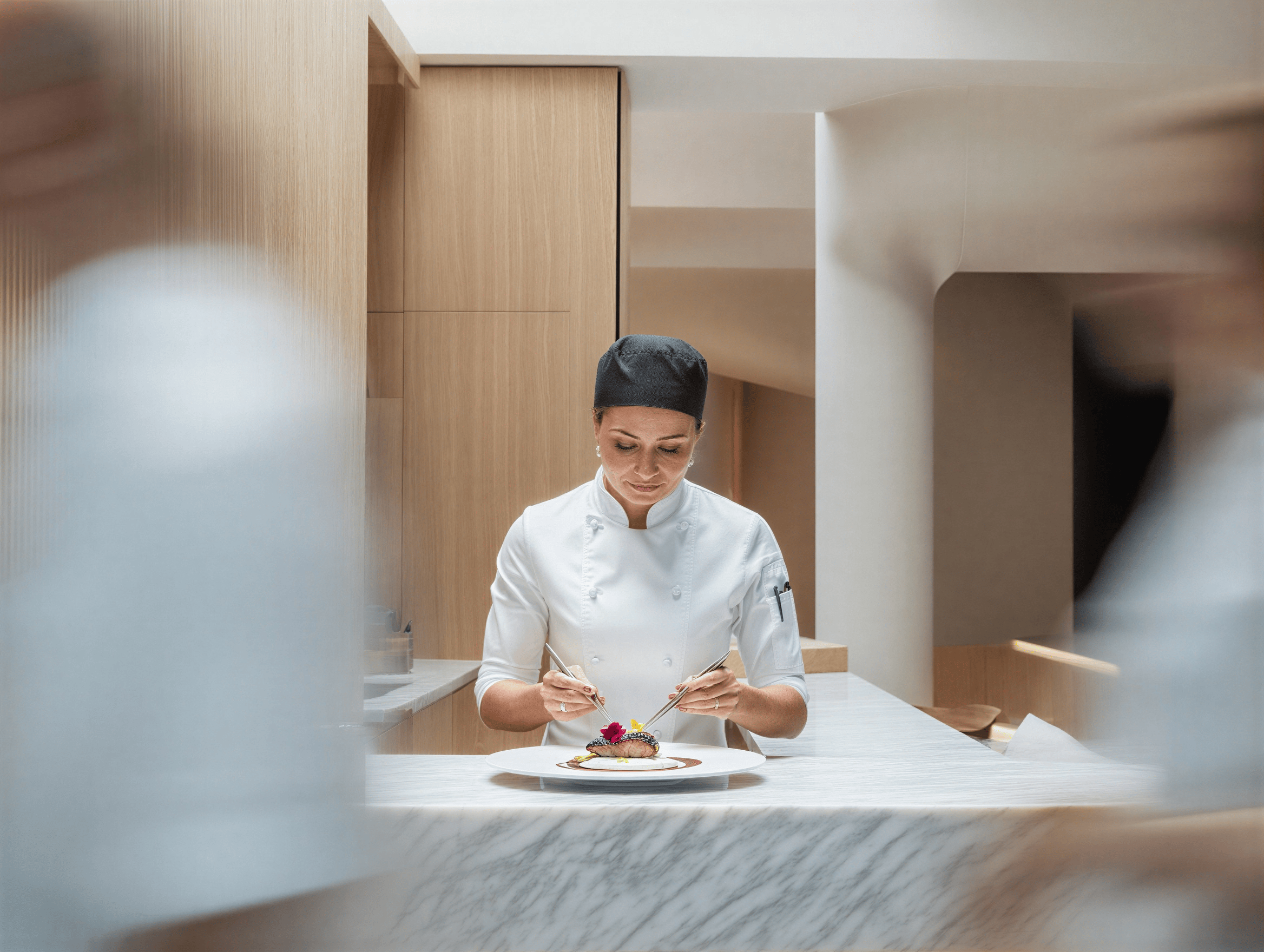 Chef meticulously plating haute cuisine in minimalist kitchen